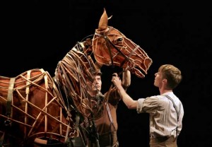 The guy in brown is one of three performers operating Joey the horse.